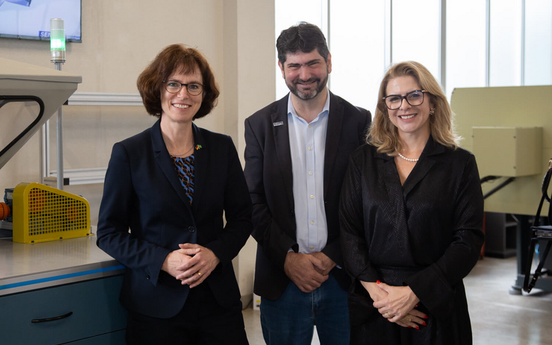 Three people smiling at the camera.