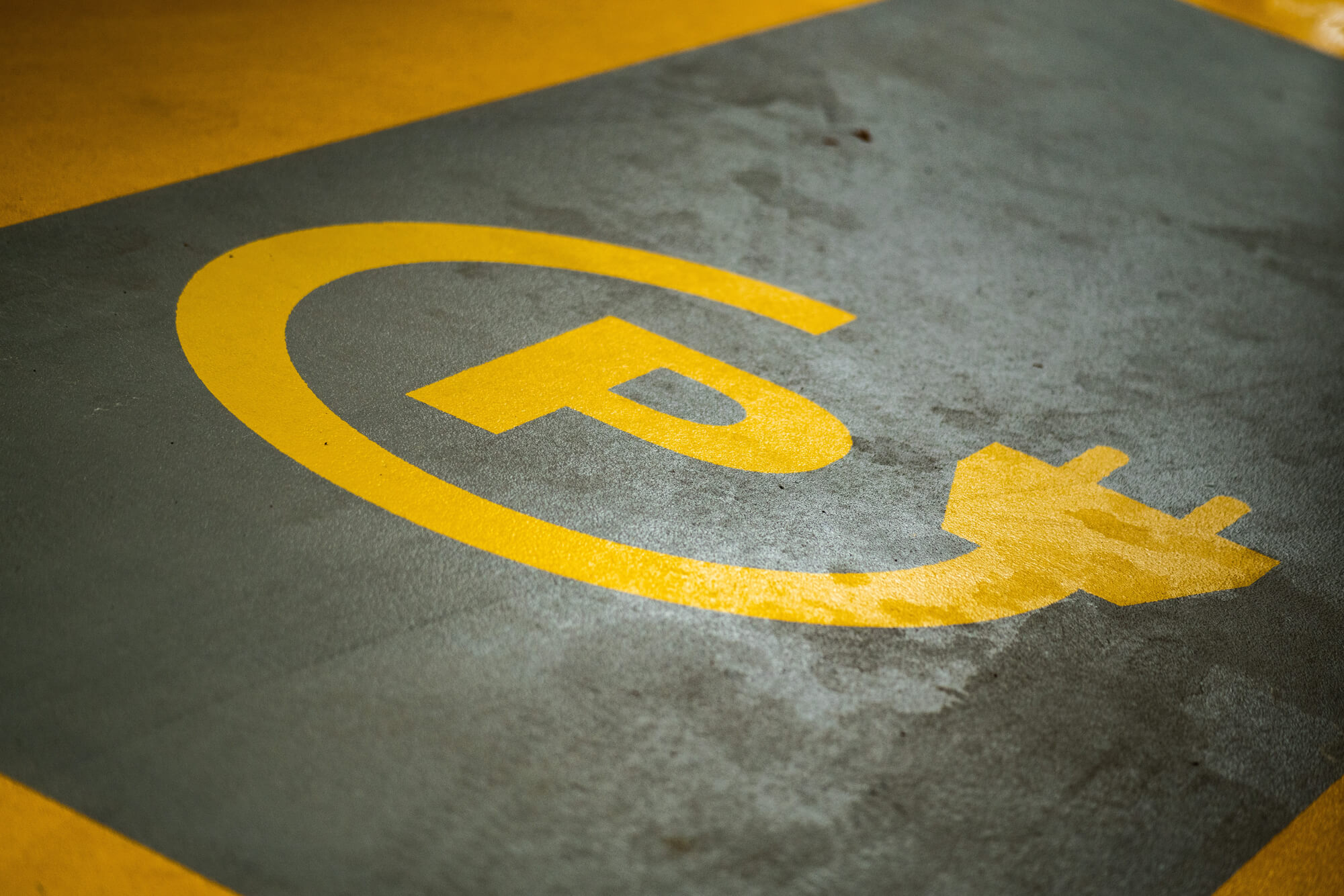 Yellow pictogram marks a parking space for electric vehicles